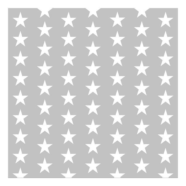 Klebefolie für Möbel Weiße Sterne auf grauem Hintergrund