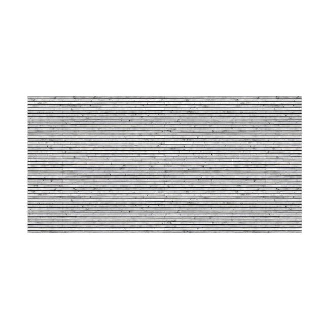 Moderner Teppich Holzwand mit schmalen Leisten schwarz weiß