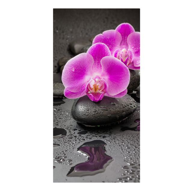 Kunstdrucke auf Leinwand Pinke Orchideenblüten auf Steinen mit Tropfen