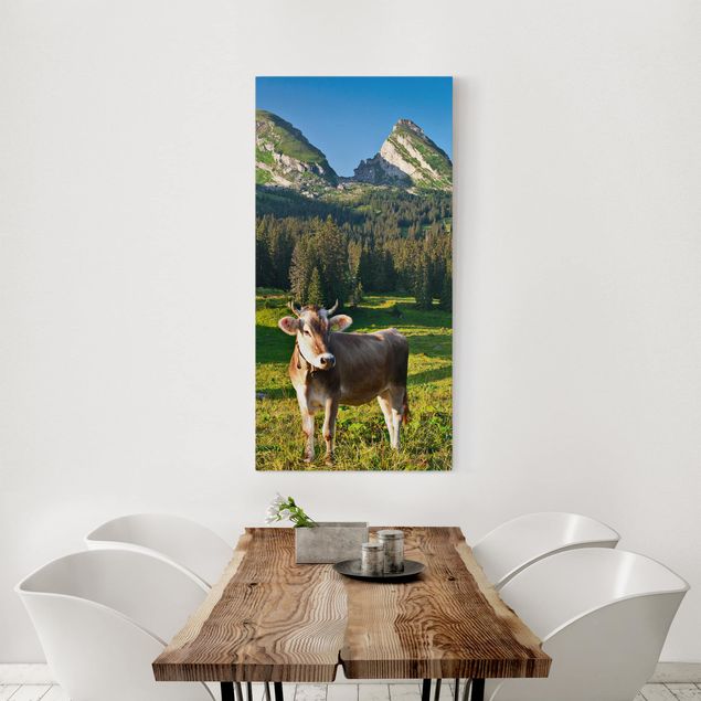 Leinwandbild Berge Schweizer Almwiese mit Kuh
