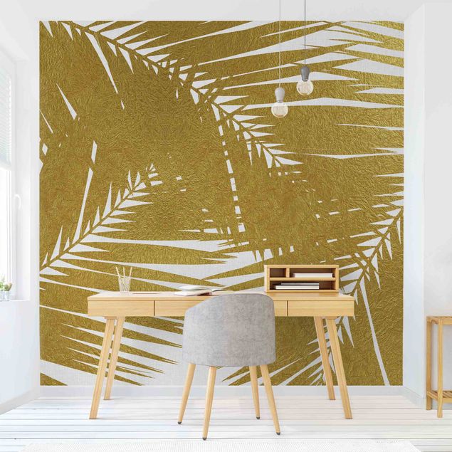 Wandtapete gold Blick durch goldene Palmenblätter