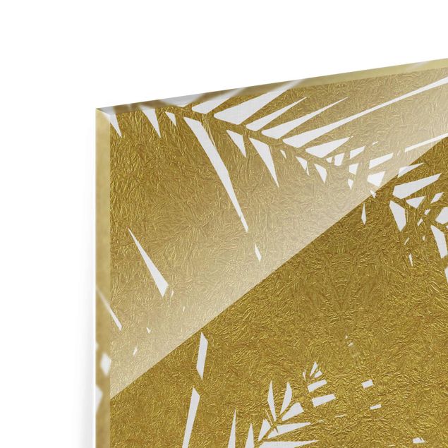 Glasbilder Blick durch goldene Palmenblätter