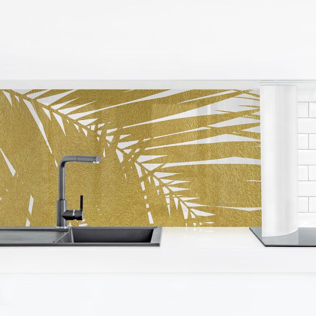 Küchenrückwand selbstklebend Blick durch goldene Palmenblätter